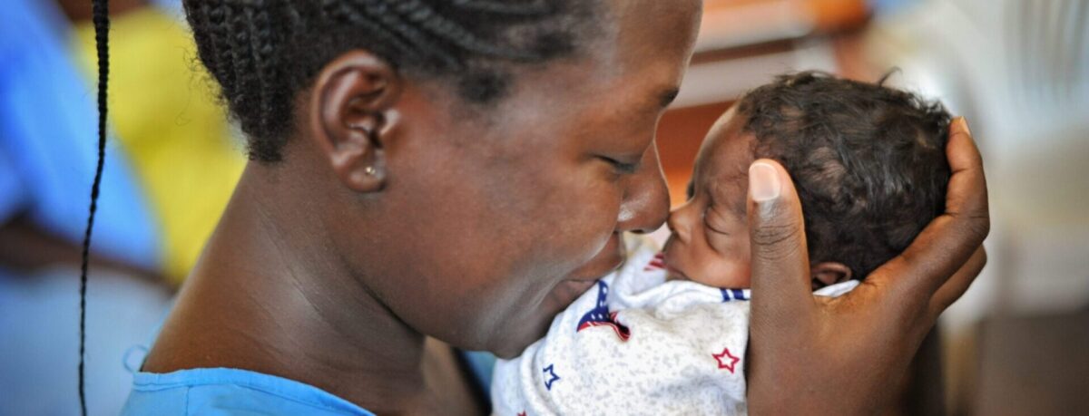 Mother lovingly holding her newborn baby.
